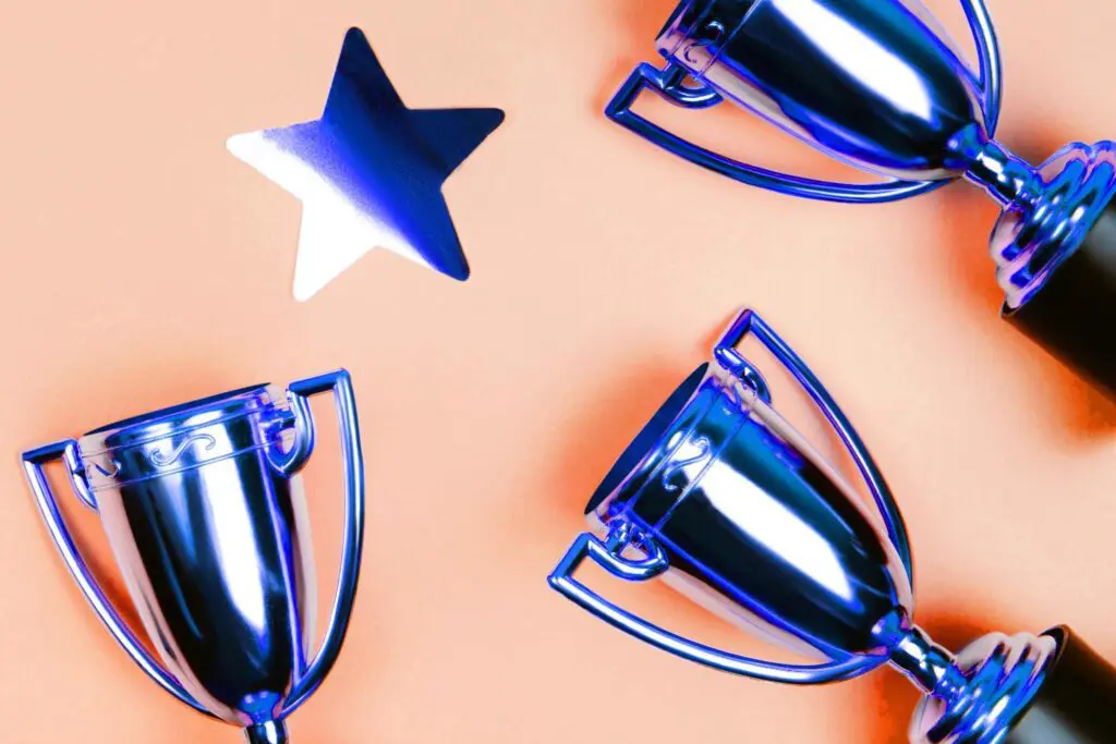 Shiny silver trophies and a blue star on an orange background.