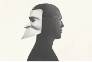An optical illusion showing two faces, one in profile and one looking forward.