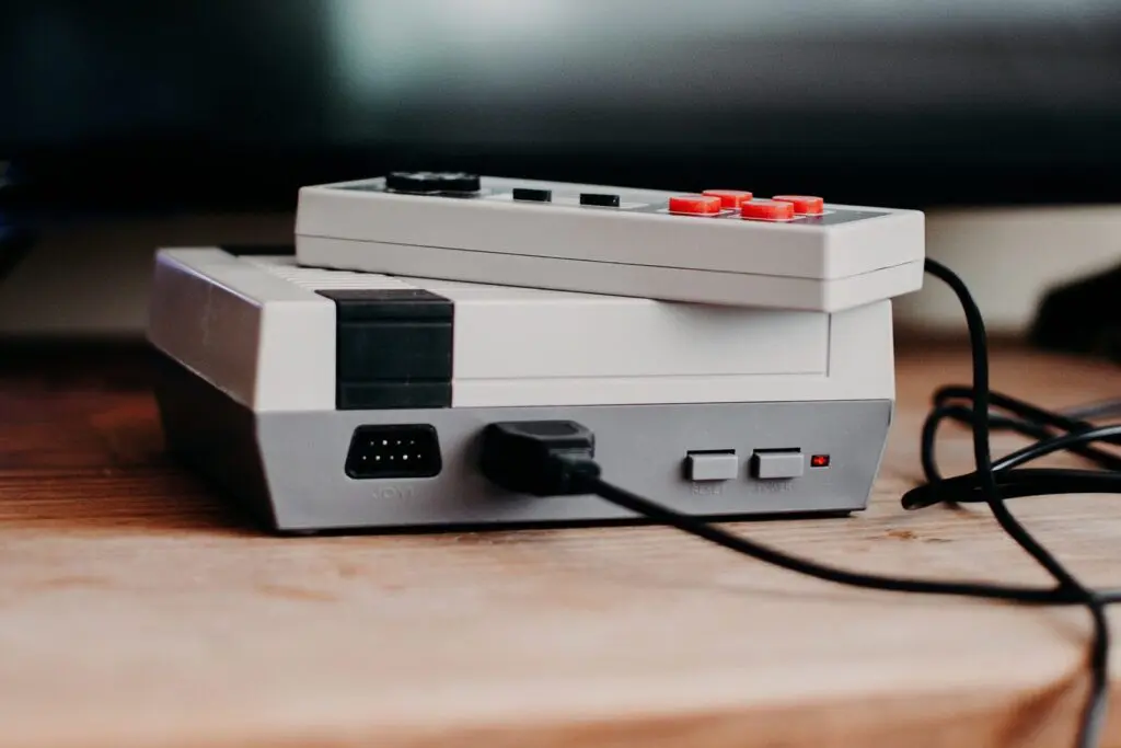 Classic retro gaming console with controllers on top, ready for play.