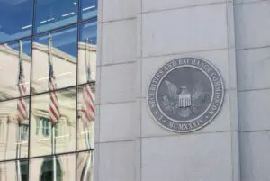 Seal of the United States Department of Justice on a building exterior.